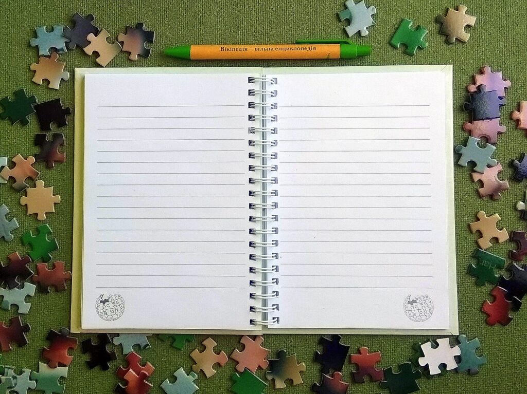 Quaderno aperto e penna sul tavolo della cucina con una lista in preparazione