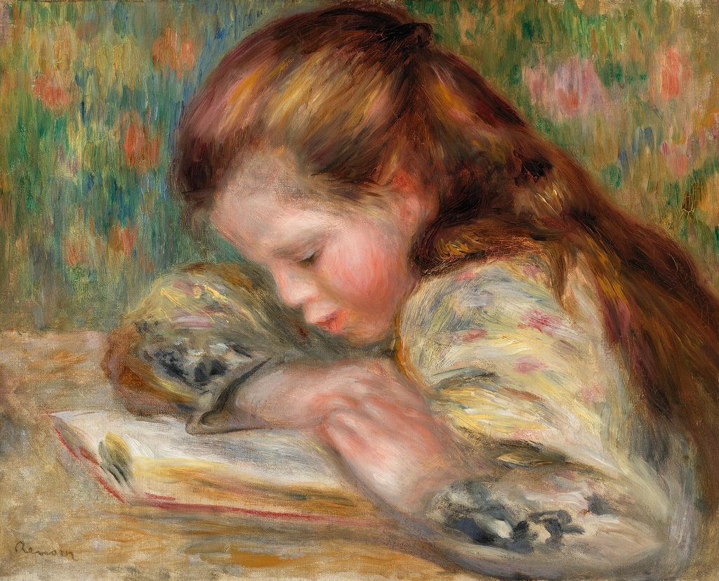 Bambino seduto sul pavimento che sfoglia un albo illustrato con illustrazioni colorate